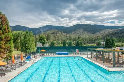 a pool at a resort with mountains in the background at Pine Mountain Club Cabin Rental with Pool Access! in Pine Mountain Club