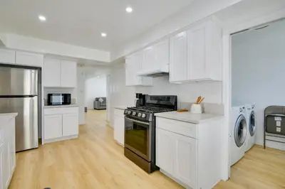 a kitchen with white cabinets and a stove at Home Between Los Angeles and Disney! Patio, Yard in Pico Rivera