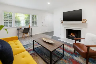 a living room with a couch and a fireplace at Quaint 1BD 1BA Bungalow in Los Angeles