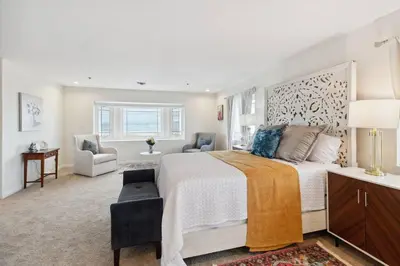 a bedroom with a large bed and two chairs at The Big Sky in Pearblossom