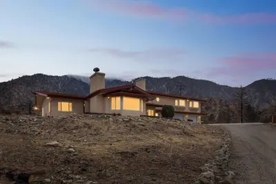a house on top of a hill with a road at The Big Sky in Pearblossom