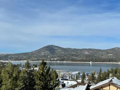 a view of a lake with mountains in the background at Big Bear Village View Haus is a large pet and kid friendly chalet with hot tub located a short walk to village in Big Bear Lake
