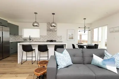 a living room and kitchen with a gray couch and a counter at 5609 East Seaside Walk in Long Beach
