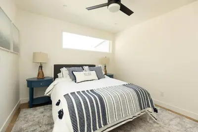 a bedroom with a bed with a black ceiling fan at 5609 East Seaside Walk in Long Beach