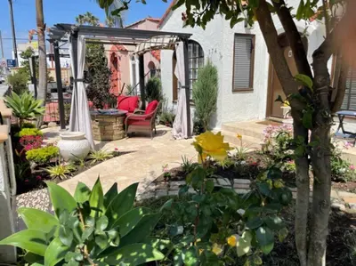 a patio with a gazebo and chairs and flowers at The Heart of Belmont Shore in Long Beach