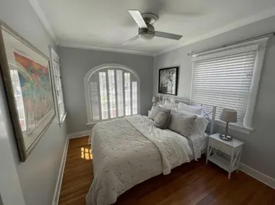 a bedroom with a bed and a ceiling fan at The Heart of Belmont Shore in Long Beach