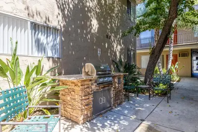 a outdoor grill with chairs and a table at Sherman Oaks 1BR w Pool Gym BBQ nr TJ WF LAX-487 in Los Angeles