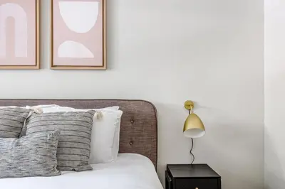 a bedroom with a bed with two pictures on the wall at Sherman Oaks 1BR w Pool Gym BBQ nr TJ WF LAX-487 in Los Angeles