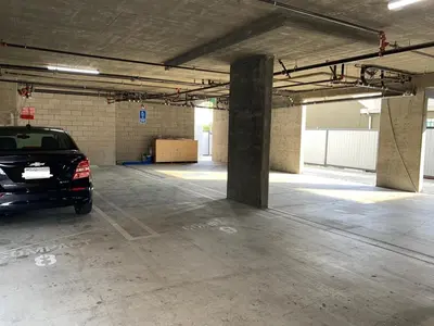 a parking garage with a car parked in it at Cozy Oasis near Griffith Observatory in Los Angeles