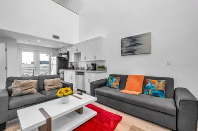 a living room with two couches and a table at Cozy Oasis near Griffith Observatory in Los Angeles