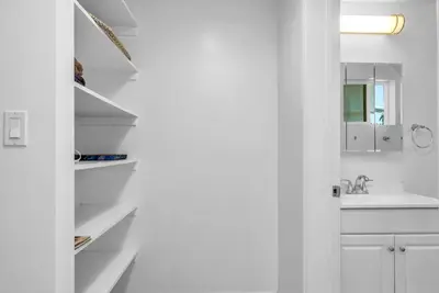 a white kitchen with a sink and a white cabinet at Cozy Oasis near Griffith Observatory in Los Angeles