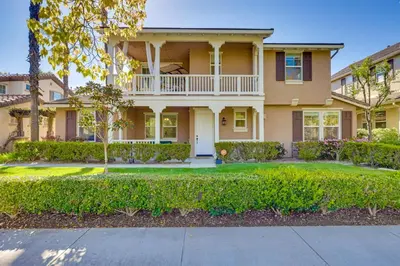 a large house with a porch and a driveway at Family-Friendly Camarillo Home with Access to Pools! in Camarillo