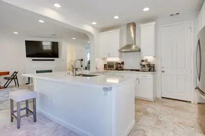 a white kitchen with a sink and a counter at Family-Friendly Camarillo Home with Access to Pools! in Camarillo