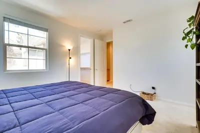 a bedroom with a large purple bed with a window at Family-Friendly Camarillo Home with Access to Pools! in Camarillo