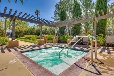 a swimming pool in a backyard with a pergola at Family-Friendly Camarillo Home with Access to Pools! in Camarillo