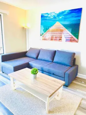 a living room with a blue couch and a coffee table at Beautiful home near Disneyland. Entire place! in Orange