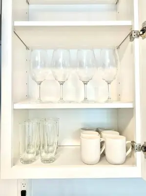 a cabinet filled with glasses and plates and cups at Cozy house near Disney, Knott’s & Beach!! in Fullerton