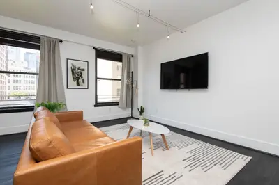a living room with a couch and a table at Audemar Boutique Hotel and Apartment Homes in Los Angeles