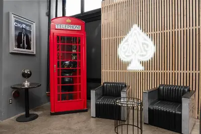 a red phone booth and two chairs in a room at Audemar Boutique Hotel and Apartment Homes in Los Angeles