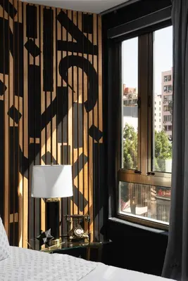 a bedroom with a bed and a window at Audemar Boutique Hotel and Apartment Homes in Los Angeles