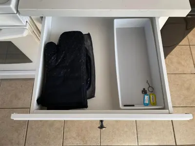 a white drawer with a black bag inside of it at Hot Tub-EV-Kid Friendly-Arcade Game-BBQ-Fire Pit in Lake Arrowhead
