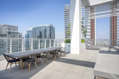 a table and chairs on the roof of a building at Downtown 1BR w Pool Jacuzzi Gym nr 110 LAX-836 in Los Angeles