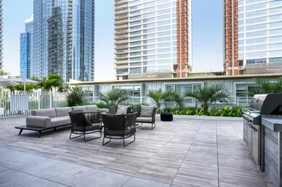 a patio with chairs and tables and tall buildings at Downtown 1BR w Pool Jacuzzi Gym nr 110 LAX-836 in Los Angeles