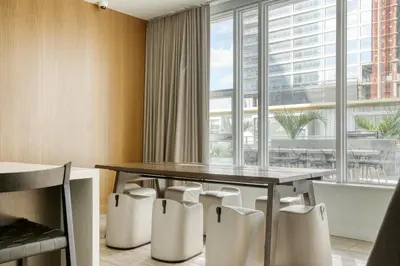 a dining room with a table and chairs and a large window at Downtown 1BR w Pool Jacuzzi Gym nr 110 LAX-836 in Los Angeles