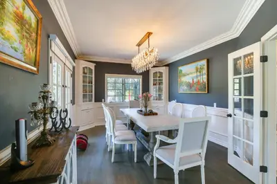 a dining room with a table and chairs at Stunning Home in Orange County with Stables! in Orange