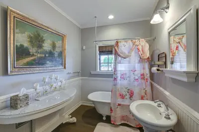 a white bathroom with a sink and a toilet and a sink at Stunning Home in Orange County with Stables! in Orange
