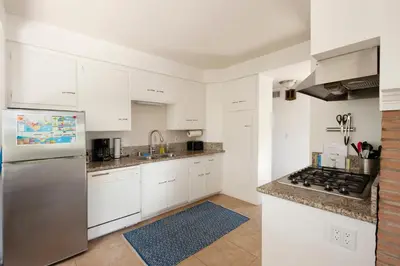 a kitchen with white cabinets and a stainless steel refrigerator at 30 PCT OFF! Malibu Peaceful Getaway, Beach, Ocean in Malibu