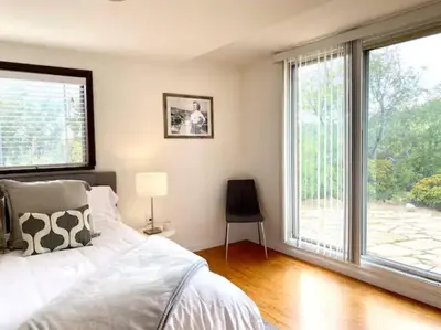 a bedroom with a bed and a large window at 30 PCT OFF! Malibu Serene Cottage with King Bed, Beach, BBQ in Malibu