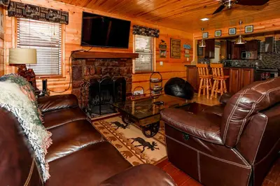 a living room with leather furniture and a fireplace at Circle Views by Big Bear Vacations Walk To Lake Boulder Bay Chalet in Big Bear Lake