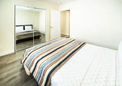 a bedroom with a bed and a large mirror at Large Condo Sleeps 10 near Downtown Los Angeles in Los Angeles