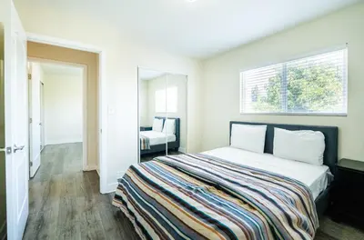 a bedroom with a large bed and a window at Large Condo Sleeps 10 near Downtown Los Angeles in Los Angeles