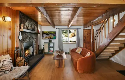a living room with a couch and a fireplace at Le Chalet of Arrowbear Lake in Running Springs